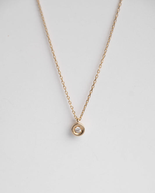 solitaire gold necklace with dimaond on it  