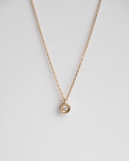 solitaire gold necklace with dimaond on it