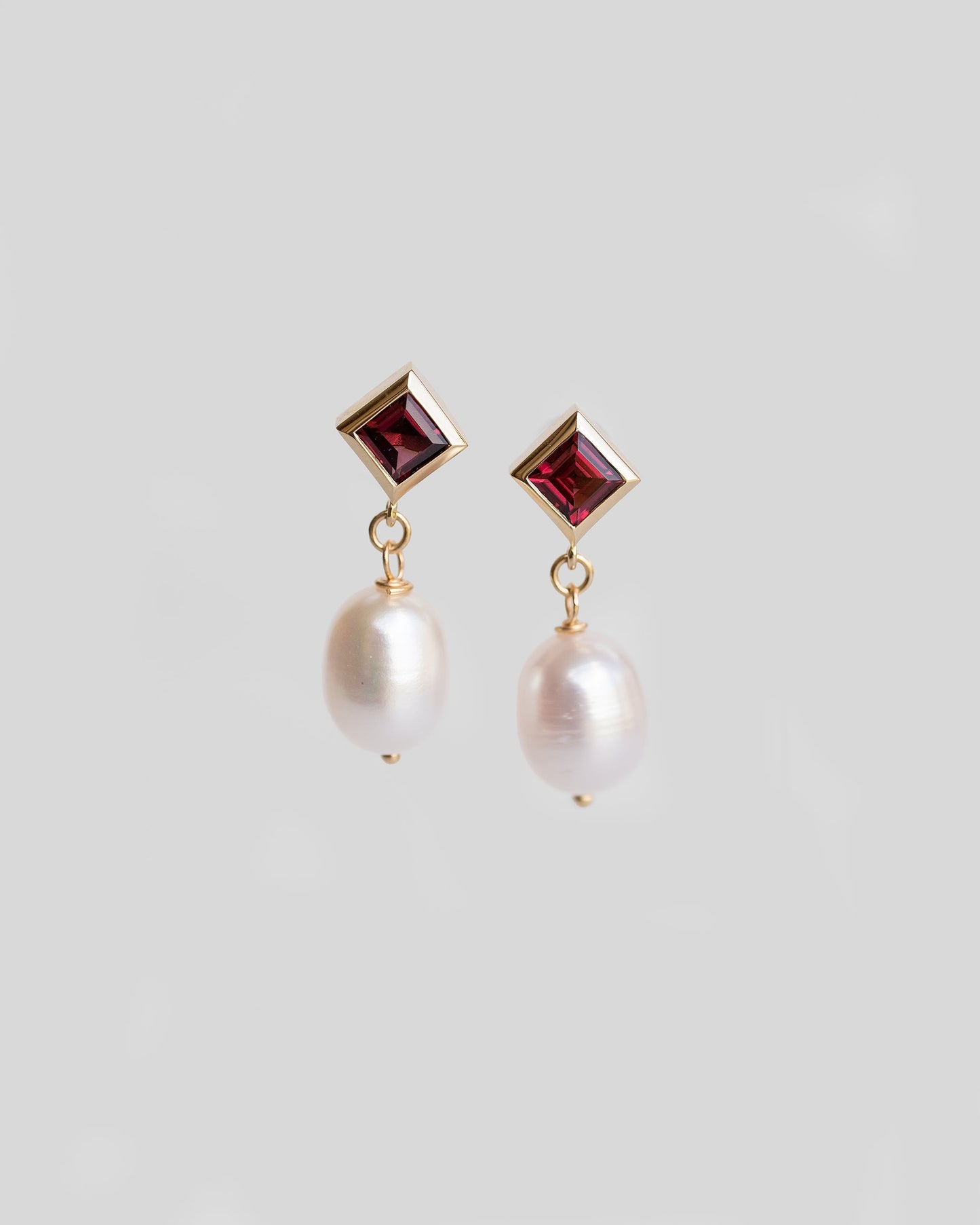 pair of gold drop earrings with garnet and freshwater pearls