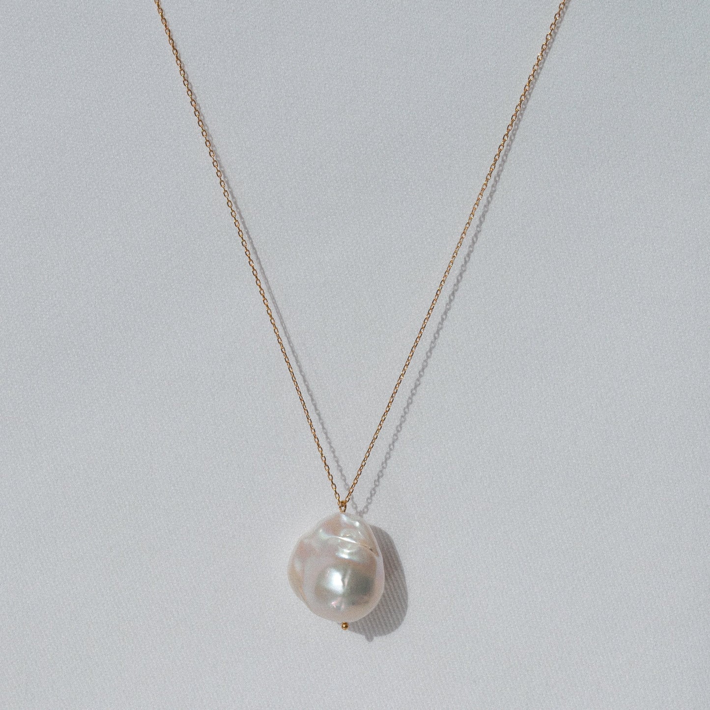 delicate gold pendant necklace with big natural baroque pearl