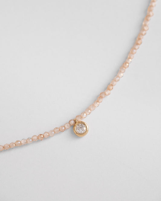 gold necklace with beige zirconia beads and real diamond