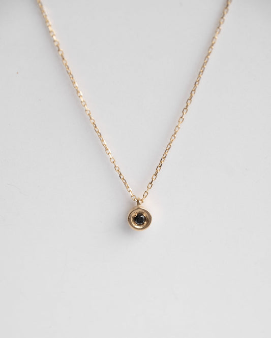 delicate gold necklace with solitaire black diamond