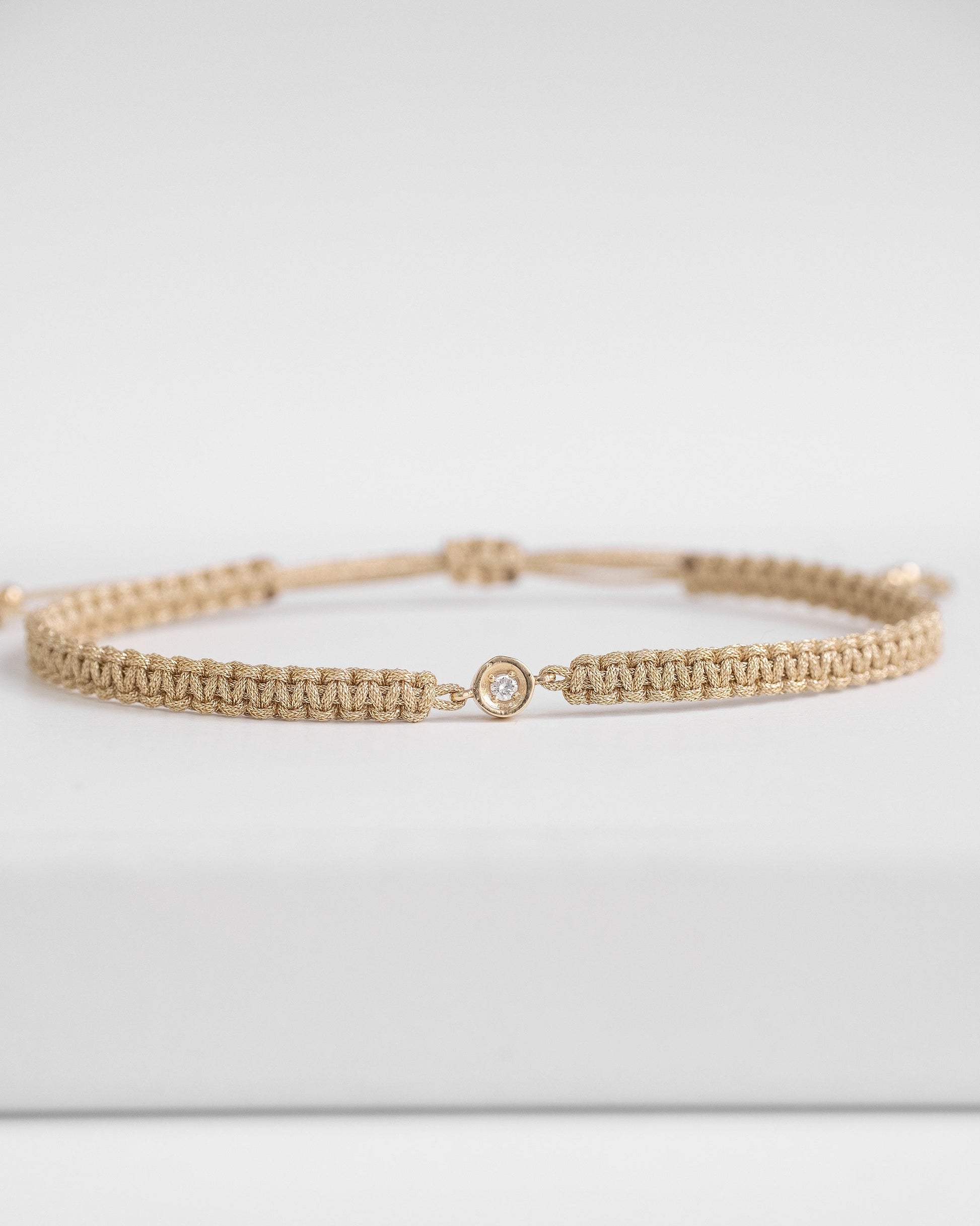 gold cord bracelet with diamond and gold clasp