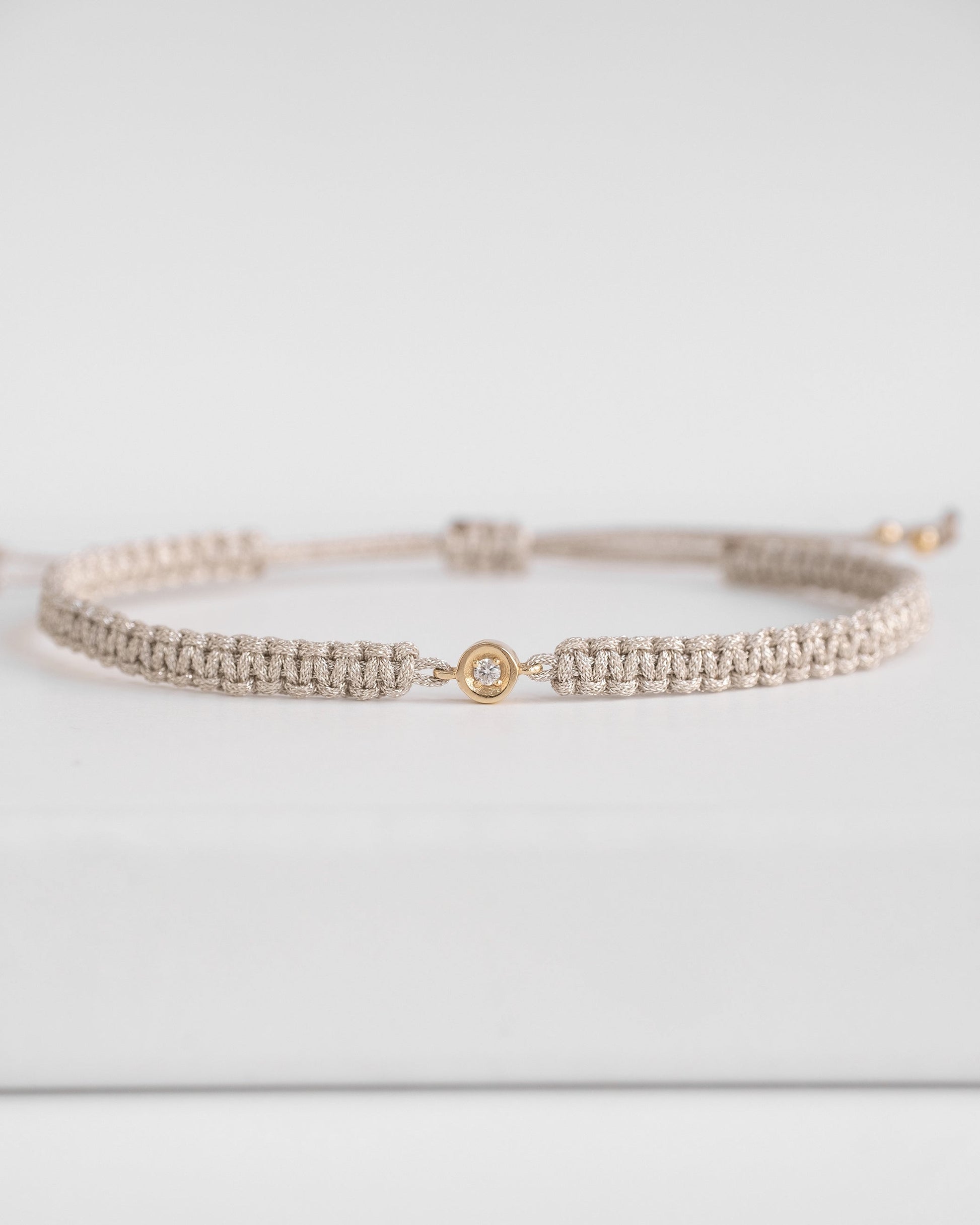 silver cord bracelet with diamond and gold clasp