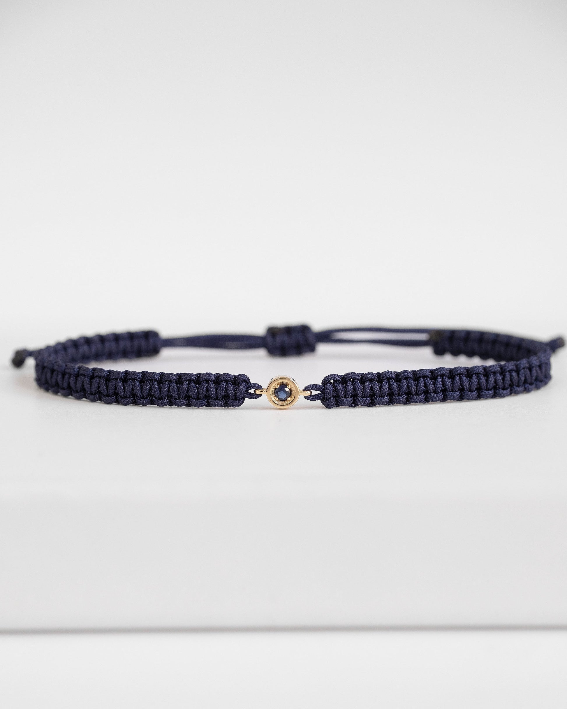 blue cord bracelet with sapphire and gold clasp  