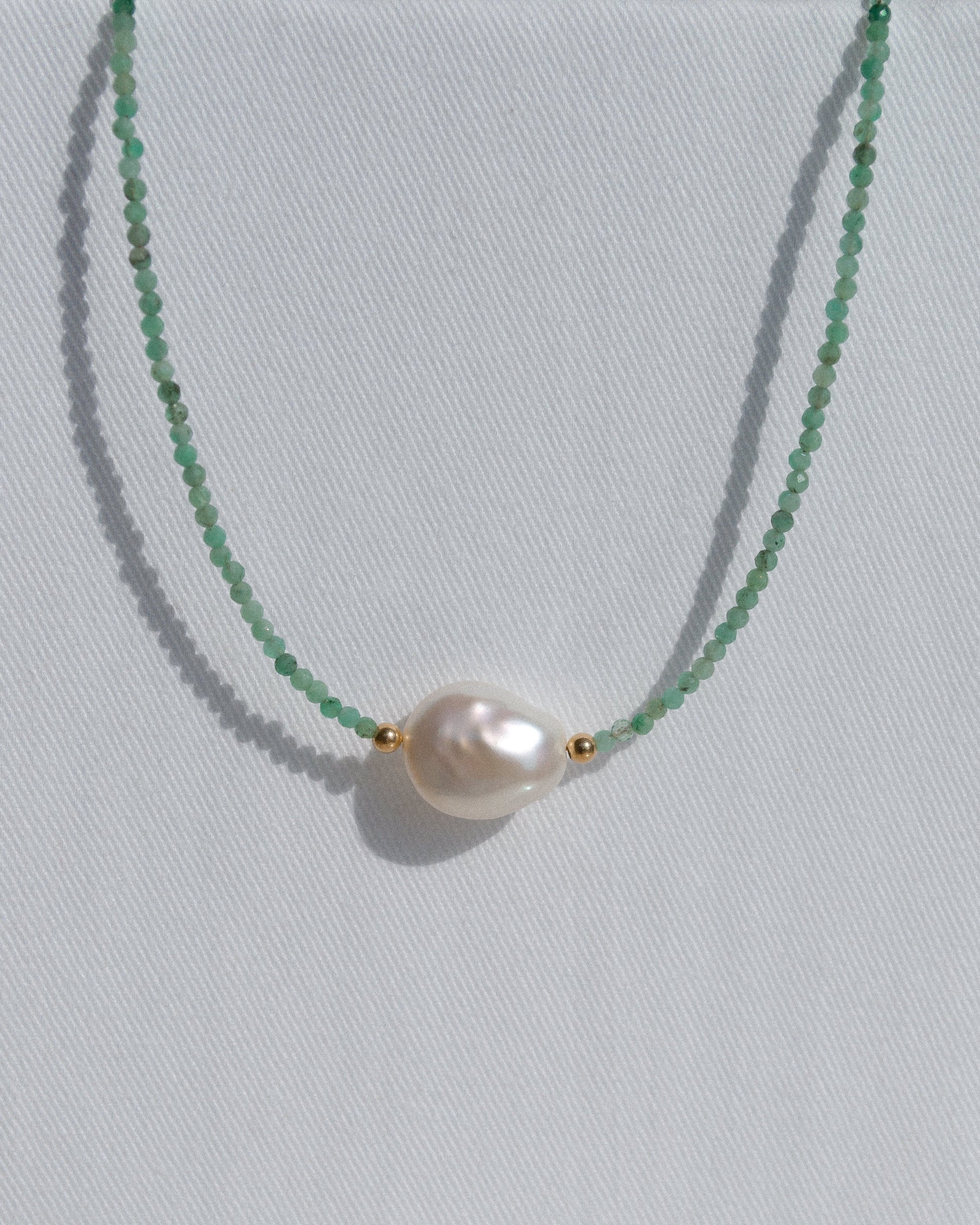 beaded gold necklace with emerald and baroque pearl 