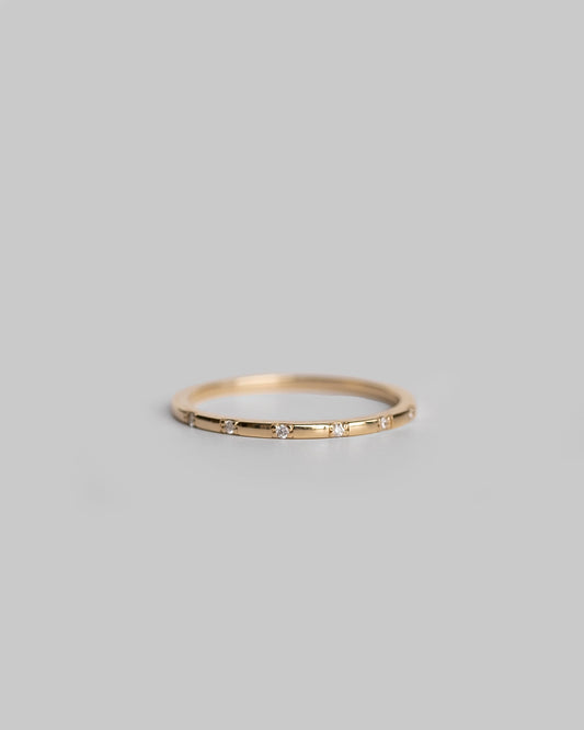 delicate gold ring with tiny diamonds