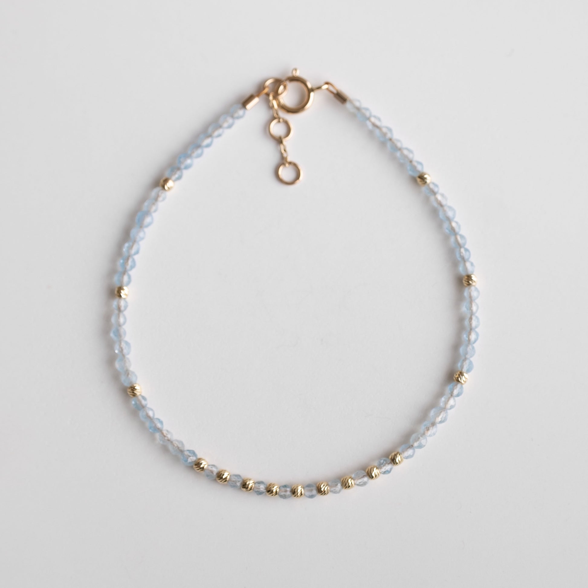 gold bracelet with delicate aquamarine stones 