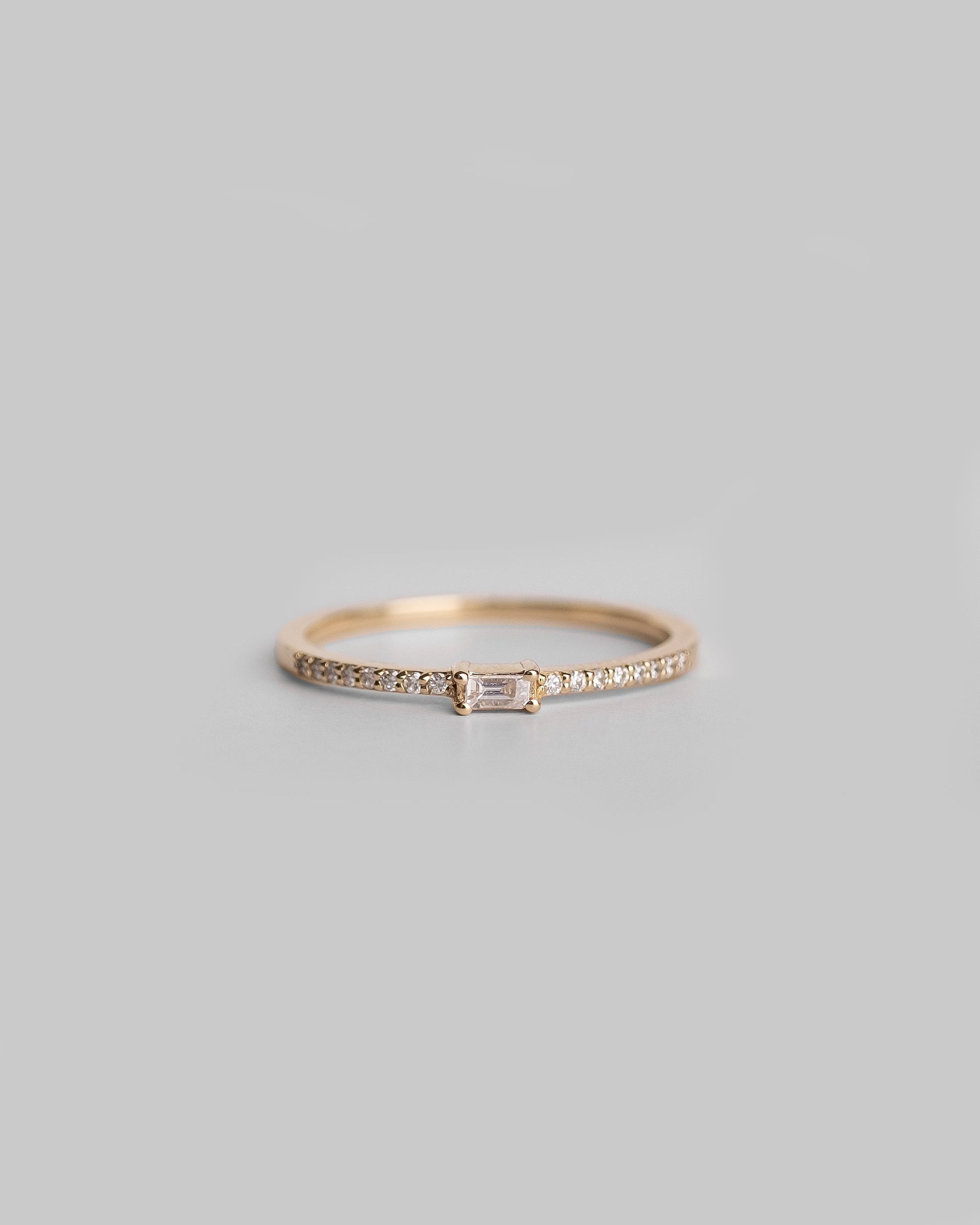 gold ring with pave round diamond band and baguette diamond 