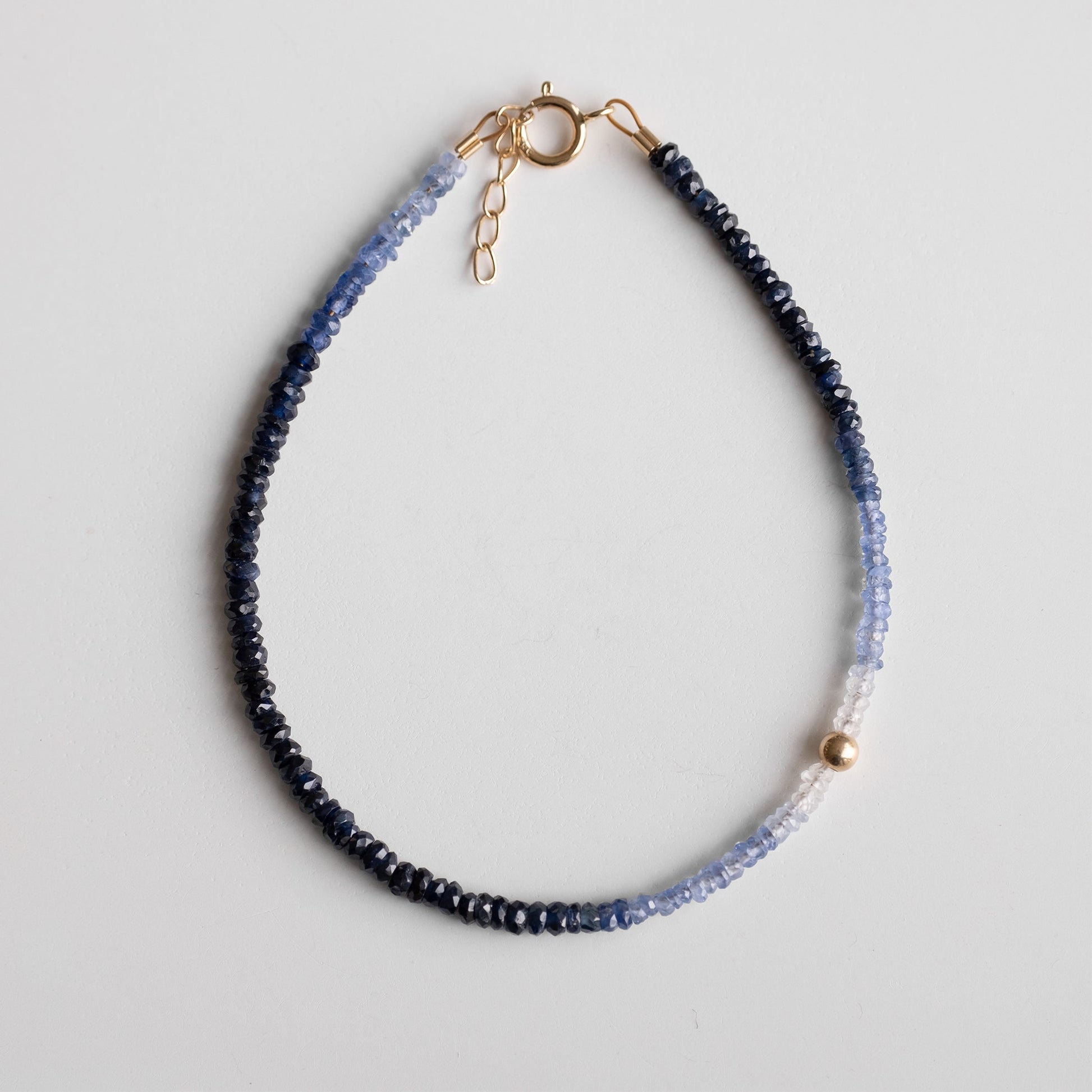 gold bracelet with shaded sapphire stones 