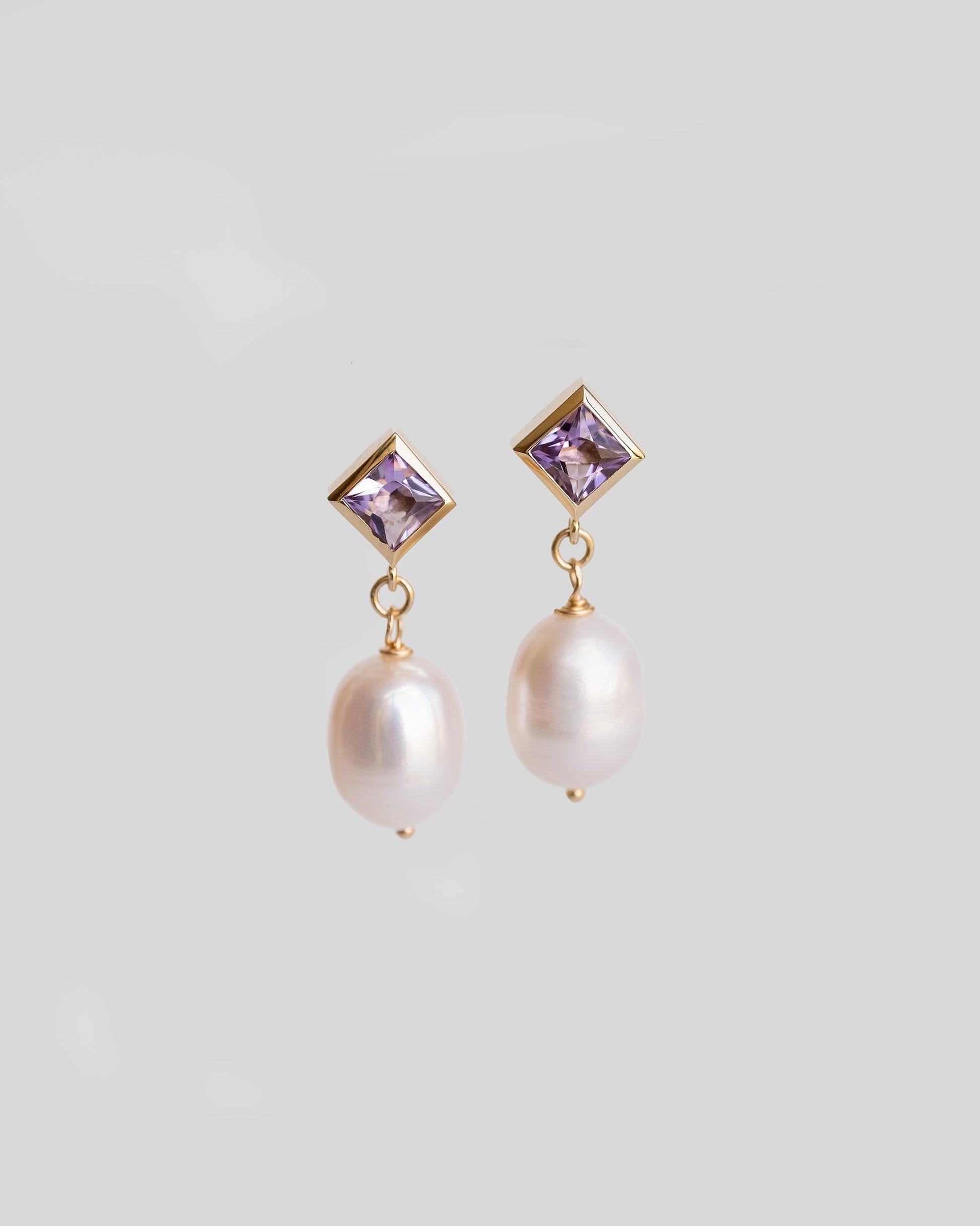 pair of gold stud earrings with purple gemstone amethyst and pearls 