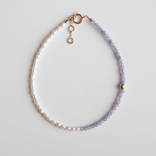 gold bracelet with pearls and purple stones