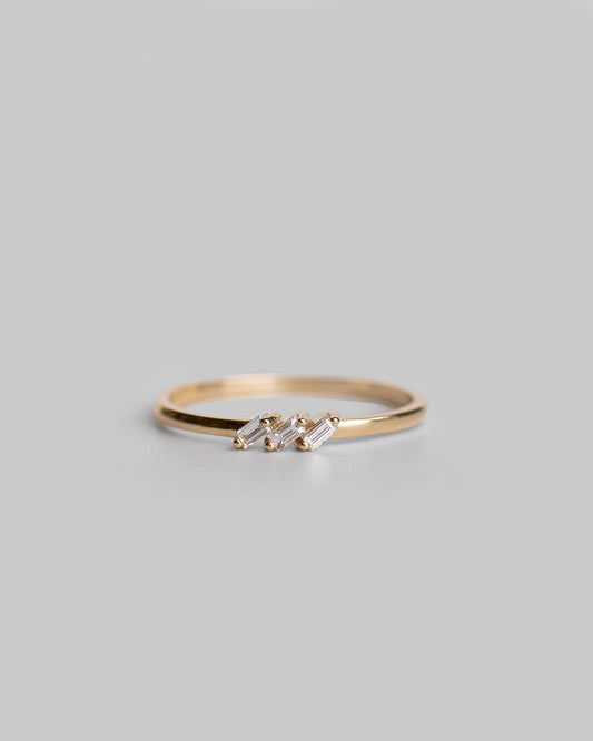 delicate gold ring with three baguette diamonds
