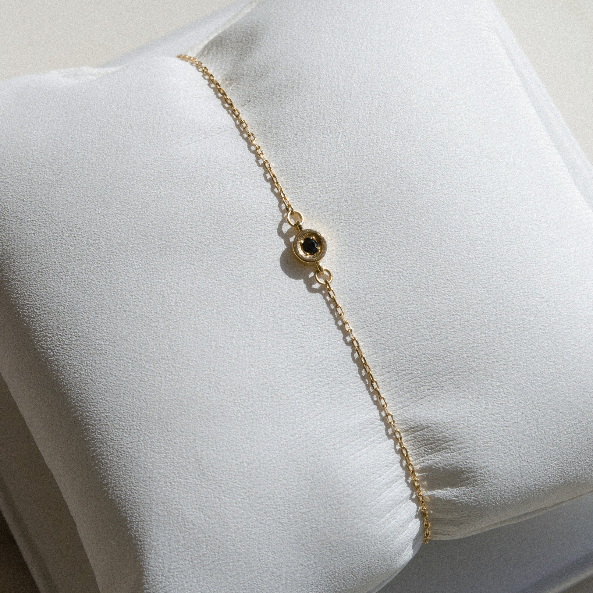 gold chain with small single black diamond 