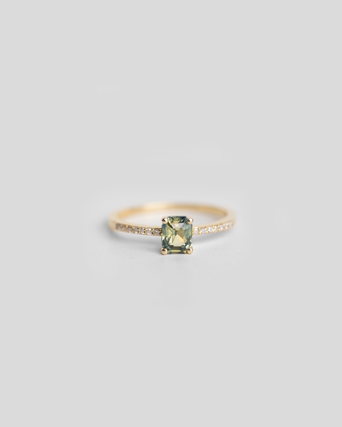 gold diamond ring with pave diamond band and green blue bi color sapphire