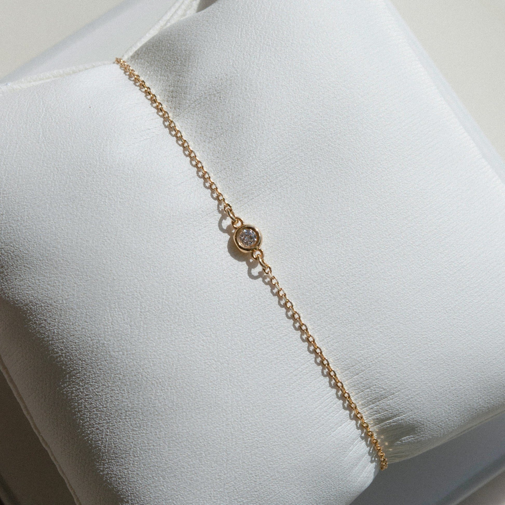 delicate gold chain bracelet with single diamond 