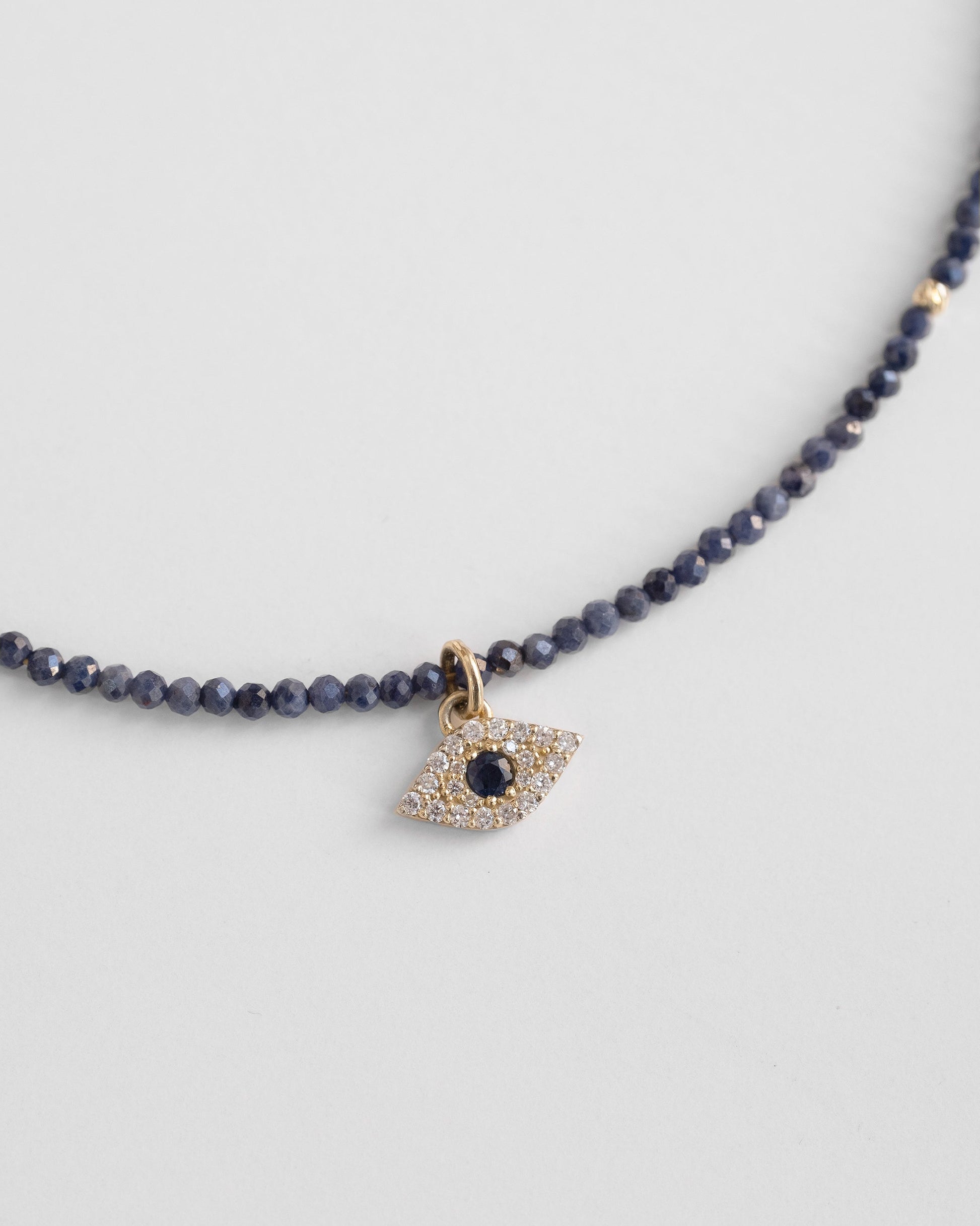 blue beaded necklace with evel eye pendant with sapphire and diamonds 