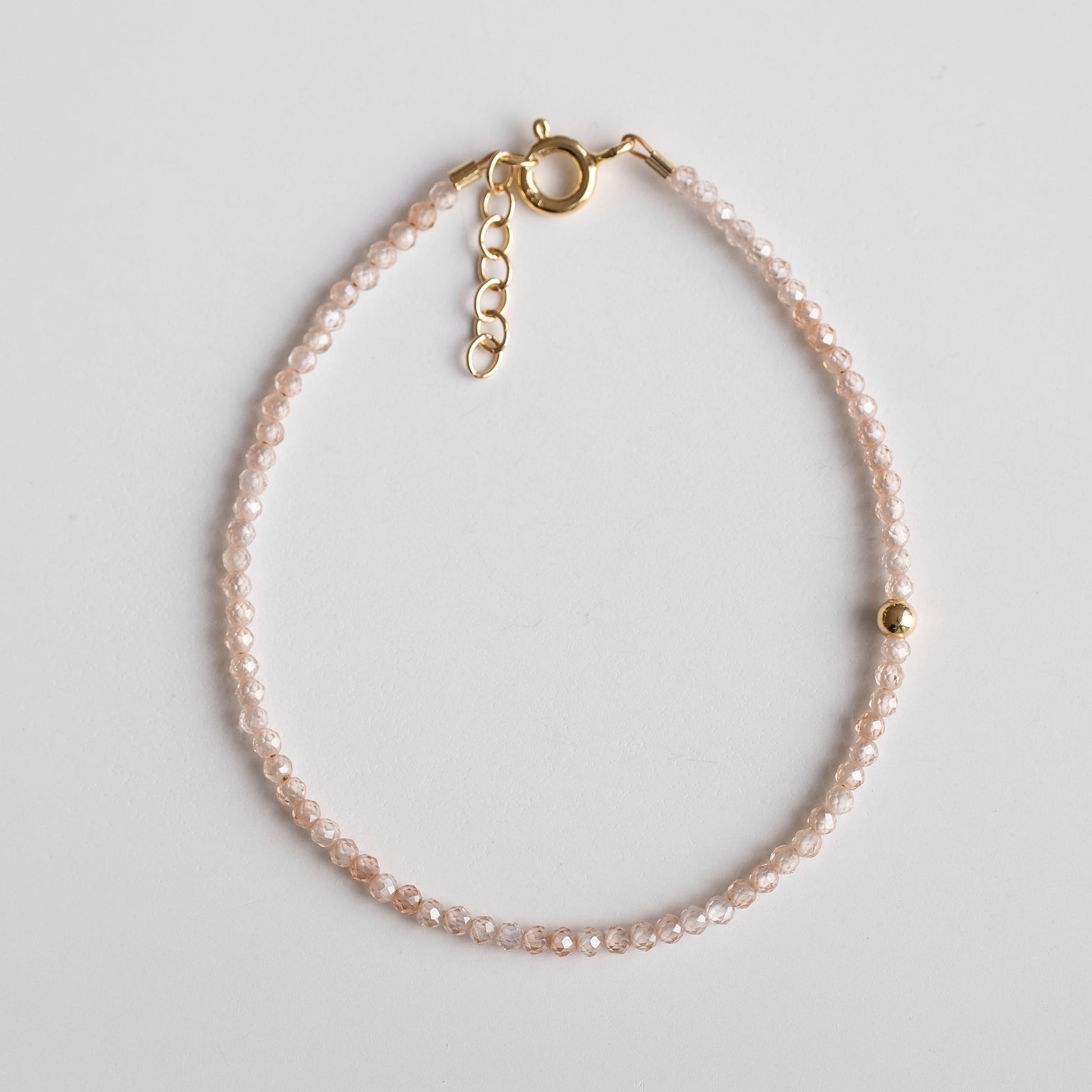 delicate gold vermeil bracelet with zirconia beads and single gold plated bead 